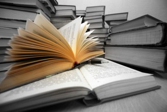 Many old books combined by a heap. Russian saying 'Knowledge - light, ignorance - darkness'